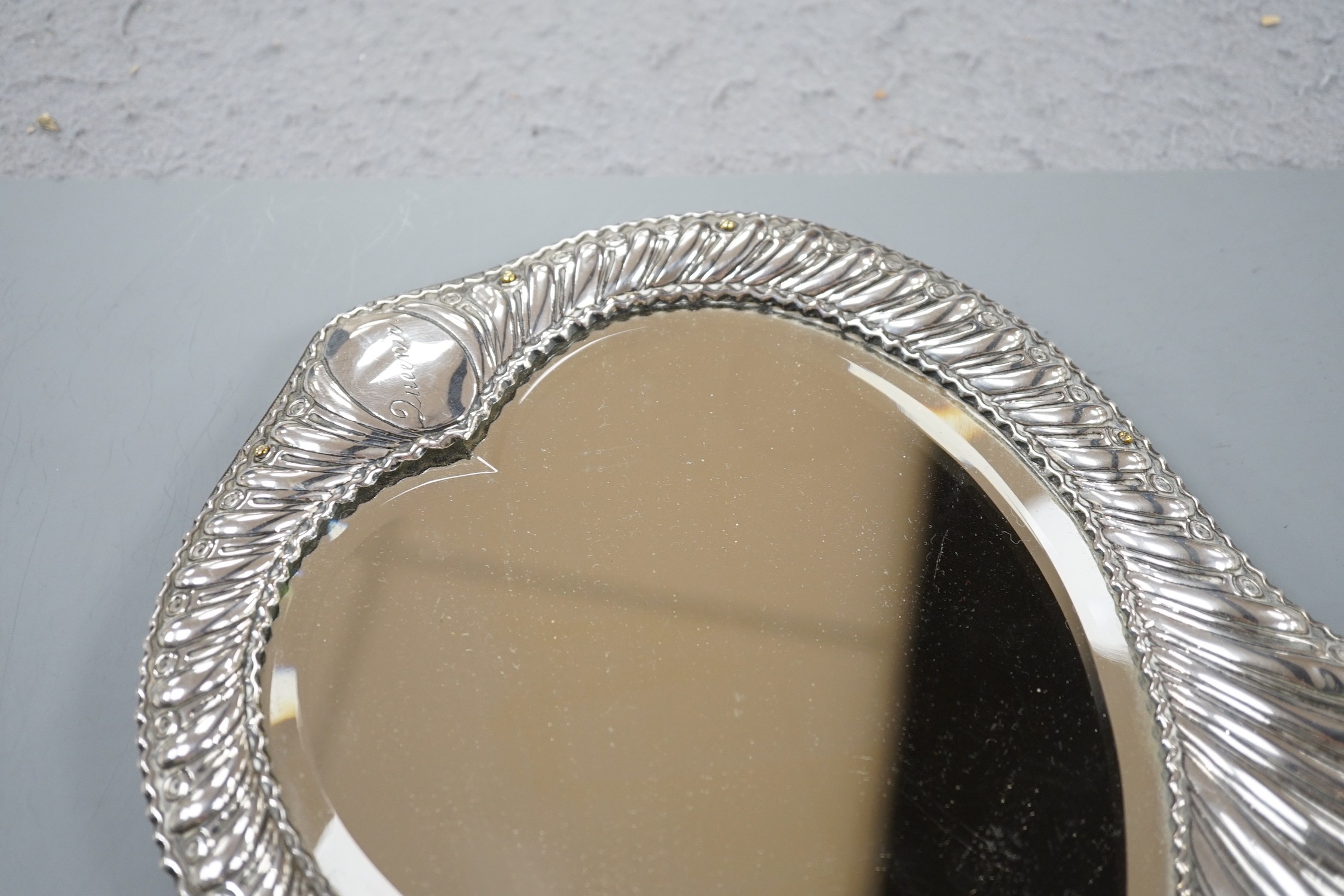 A late Victorian repousse silver mounted heart shape easel mirror, William Comyns, London, 1900, 26.5cm.